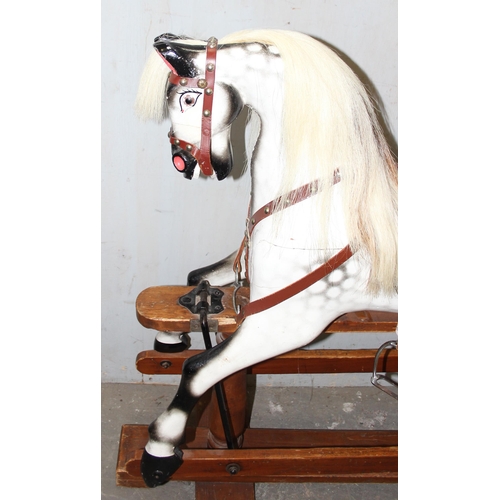 120 - A small late 19th century English carved wooden rocking horse on trestle rocker, with open mouth wit... 