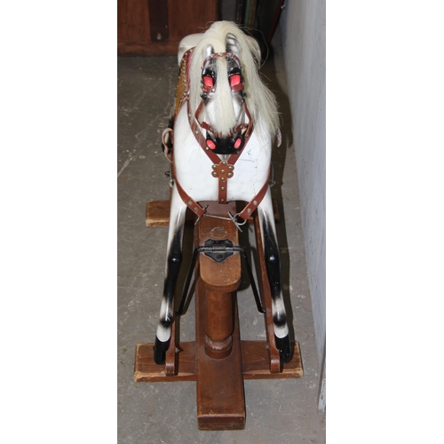 120 - A small late 19th century English carved wooden rocking horse on trestle rocker, with open mouth wit... 