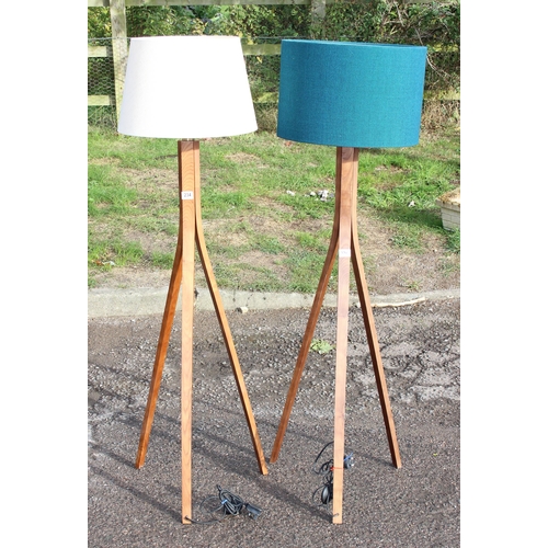 234 - A pair of retro style wooden tripod standard lamps with shades