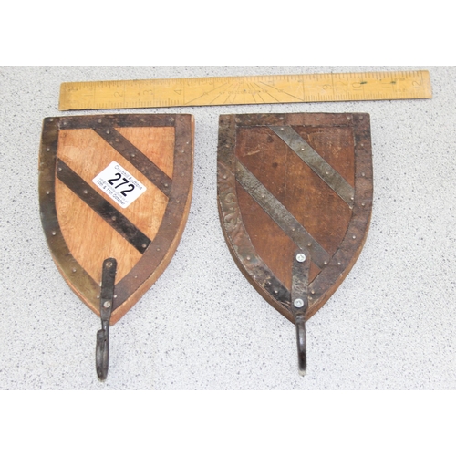 272 - A pair of wooden and iron shield shaped coat hooks