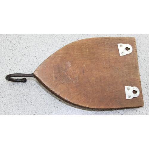 272 - A pair of wooden and iron shield shaped coat hooks