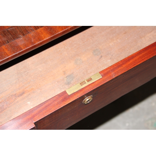 109 - An antique mahogany sofa table with hidden drawers and drop ends with crossbanded decoration