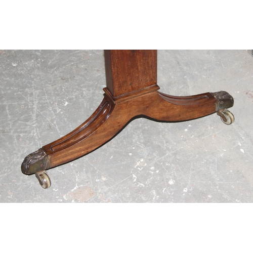 109 - An antique mahogany sofa table with hidden drawers and drop ends with crossbanded decoration