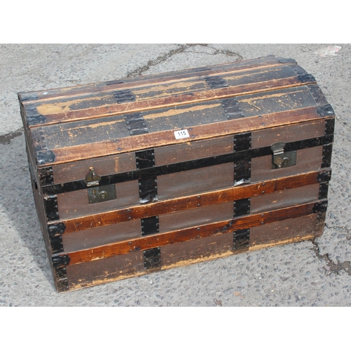 115 - A vintage iron banded dome topped travel trunk