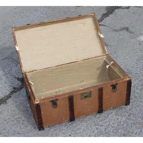 116 - A vintage wooden bound travel trunk with flat top