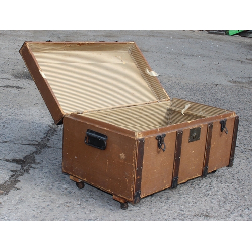 116 - A vintage wooden bound travel trunk with flat top