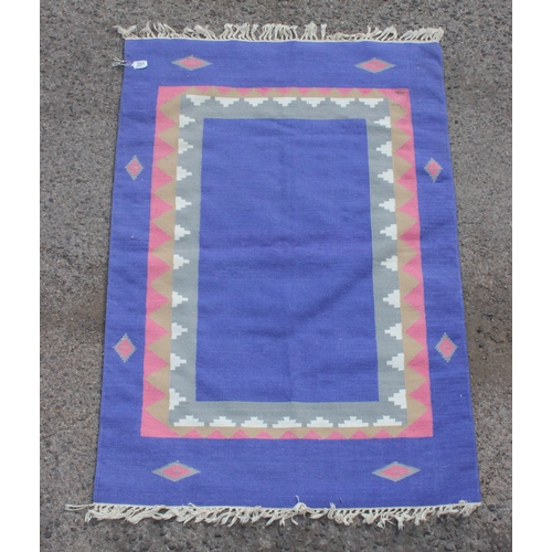 201 - A vintage blue ground flat weave rug, approx 140cm x 90cm