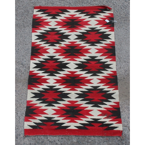 202 - A vintage flatweave rug with red ground and geometric diamonds pattern, approx 145cm x 85cm