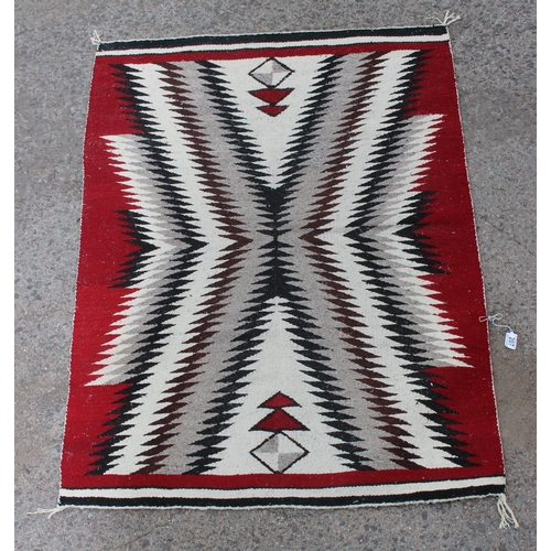 207 - A red ground flatweave rug with unusual geometric design, approx 140cm x 100cm