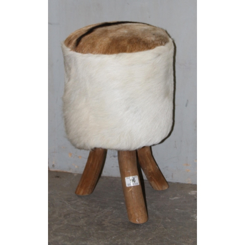 96 - An unusual animal hide upholstered stool on tripod wooden legs