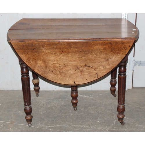 12 - An antique oak drop leaf extending table