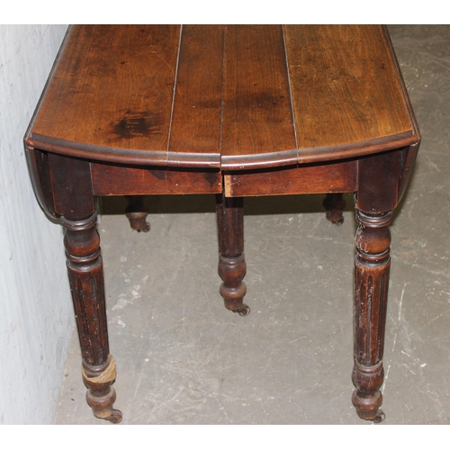 12 - An antique oak drop leaf extending table