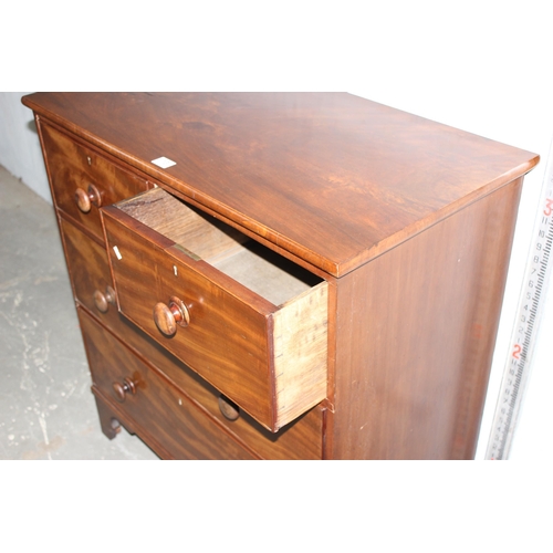 13 - An antique mahogany 2/2 chest of drawers with bracket feet and bun handles