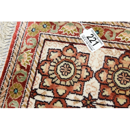 221 - A small finely woven rug of red and cream ground, believed to be silk, knot count approximately 360 ... 