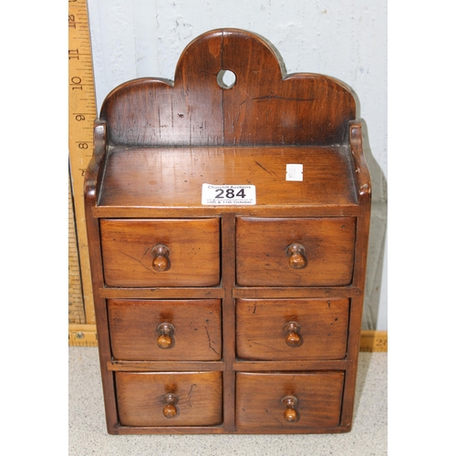 284 - A small vintage wooden 6 drawer wall hanging cabinet