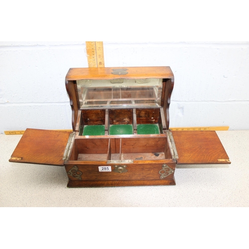 285 - An antique oak cased 3 bottle tantalus and games box