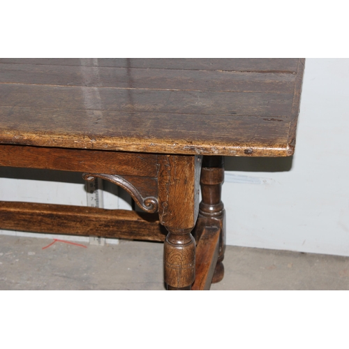 7 - An antique oak or elm 5 plank topped refectory table with turned legs, carved brackets and peg joint... 