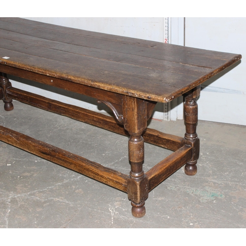 7 - An antique oak or elm 5 plank topped refectory table with turned legs, carved brackets and peg joint... 