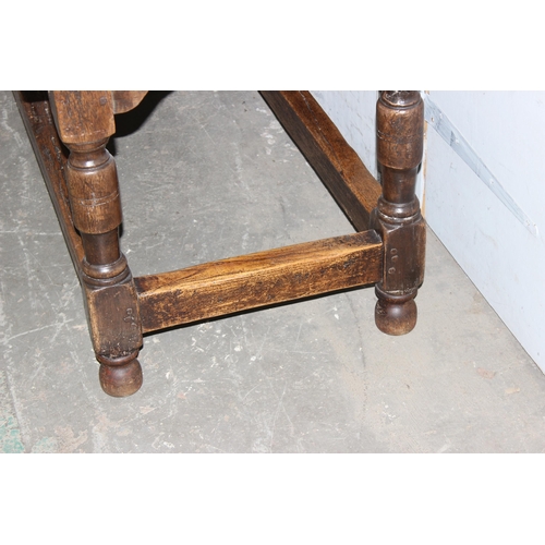 7 - An antique oak or elm 5 plank topped refectory table with turned legs, carved brackets and peg joint... 