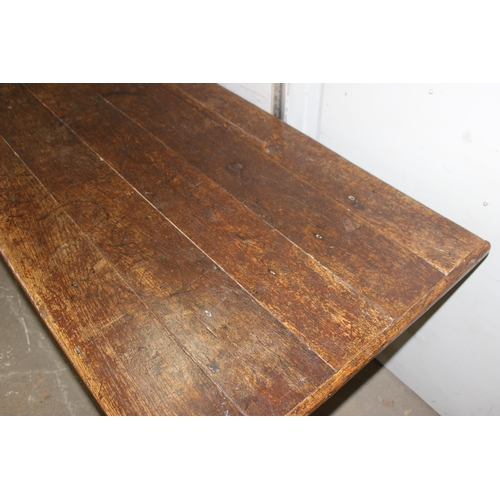 7 - An antique oak or elm 5 plank topped refectory table with turned legs, carved brackets and peg joint... 