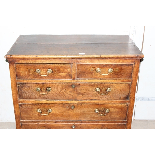 8 - An 18th century oak or elm 2 over 3 chest of drawers with brass handles and bracket feet, approx 96c... 