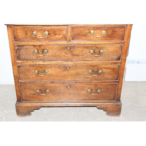 8 - An 18th century oak or elm 2 over 3 chest of drawers with brass handles and bracket feet, approx 96c... 