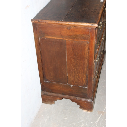 8 - An 18th century oak or elm 2 over 3 chest of drawers with brass handles and bracket feet, approx 96c... 