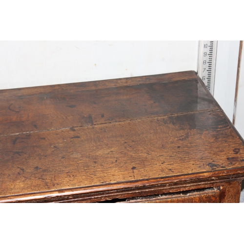 9 - An 18th century small oak sideboard with 2 deep drawers and brass handles, standing on cabriole legs... 