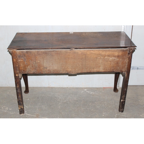 9 - An 18th century small oak sideboard with 2 deep drawers and brass handles, standing on cabriole legs... 