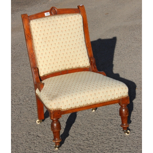 138 - A 19th century Victorian chair with cream upholstered seat and brass and ceramic castors