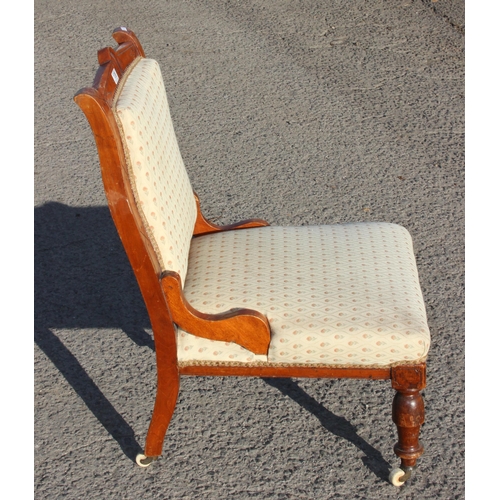 138 - A 19th century Victorian chair with cream upholstered seat and brass and ceramic castors