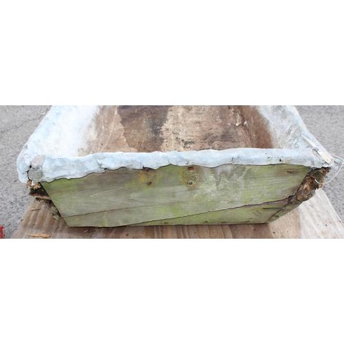 321 - A large lead lined sink with wooden carcass, approx 151cm x 75cm