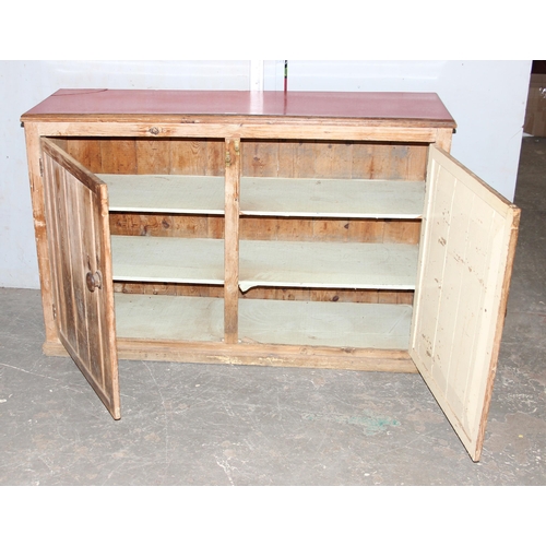 139 - A Victorian pine 2 door cupboard with later Formica top, approx 145cm wide x 95cm tall