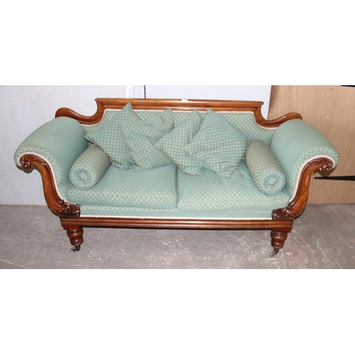 142 - A 19th century mahogany scroll arm sofa with brass cup castors, later green upholstery with matching... 