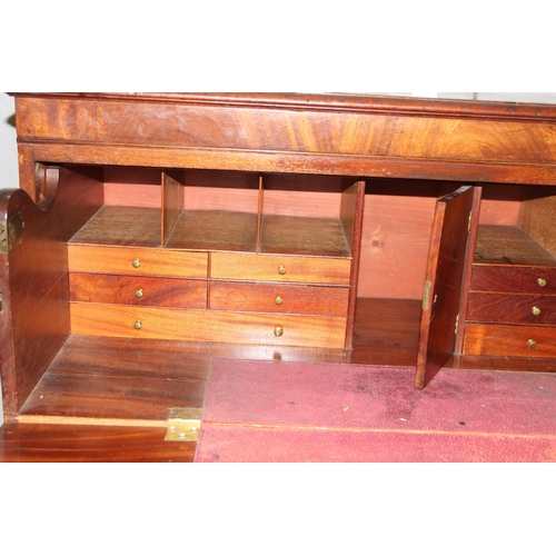 147 - A 19th century 4 drawer chest of drawers with brass handles, the top drawer being a secrétaire desk ... 