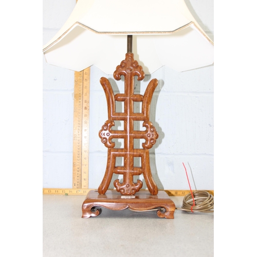 250 - A carved Chinese hardwood lamp with shade