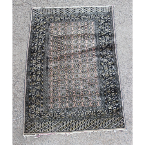 226 - A vintage grey ground rug with intricate design, approx 140cm x 90cm