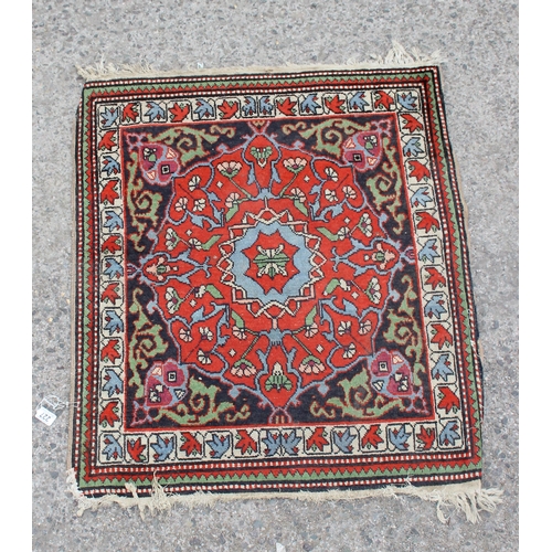 227 - A decorative vintage hand made rug of red and blue ground, approx 100cm long