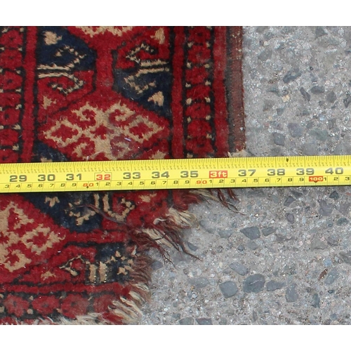 228 - A vintage signed Persian rug of red and cream ground, approx 100cm x 90cm