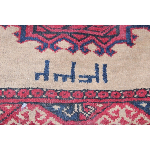 228 - A vintage signed Persian rug of red and cream ground, approx 100cm x 90cm