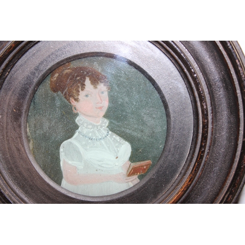 473 - 2 antique painting on glass miniatures in ebonised circular frames, various annotations verso