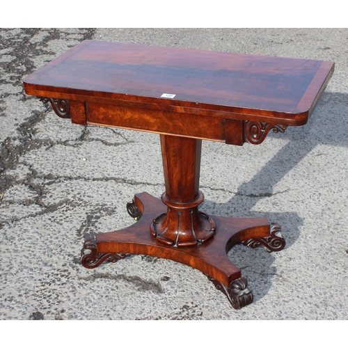 187 - A 19th century mahogany fold over card table with pedestal support