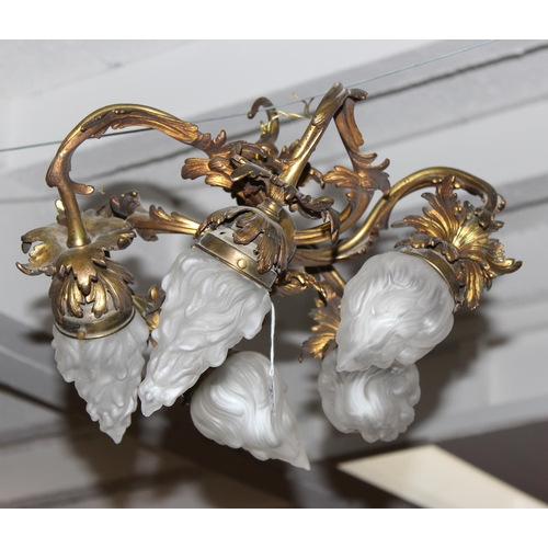 265 - A vintage gilt bronze hanging light fitting with 5 frosted glass flame designed shades