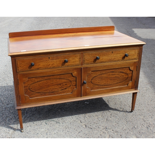 194 - An early 20th century mahogany sideboard or side cabinet with brass castors