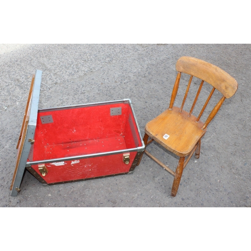 182 - A vintage red travel trunk and a child's pine stick back chair