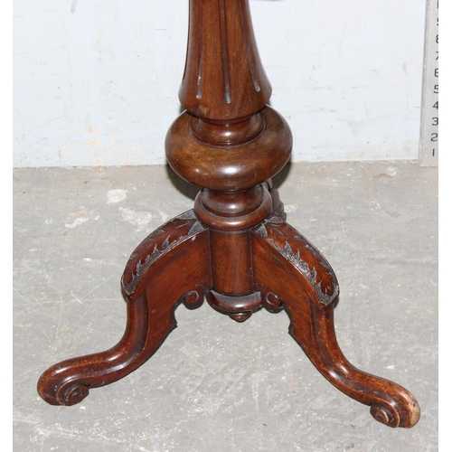 51 - An unusual antique octagonal table with removeable top and carved details on a tripod base