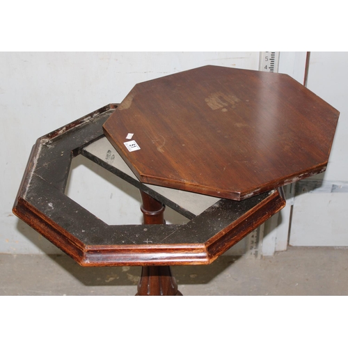 51 - An unusual antique octagonal table with removeable top and carved details on a tripod base