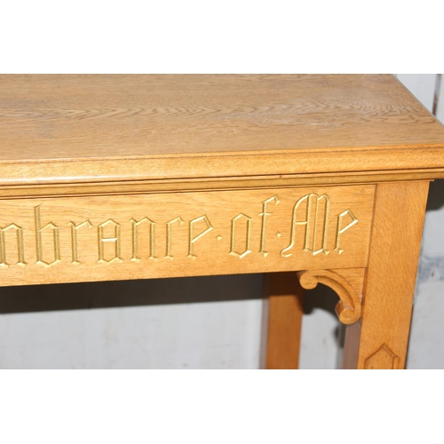 55 - A vintage light oak side table with gilt gothic script and carved Templar cross to base, likely from... 