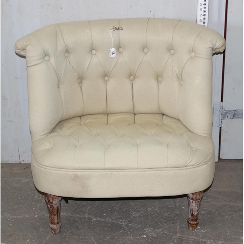 56 - An unusual button backed low tub chair with cream upholstery