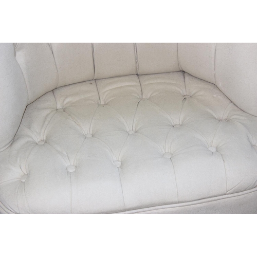 56 - An unusual button backed low tub chair with cream upholstery